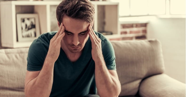 man holding head temples headache